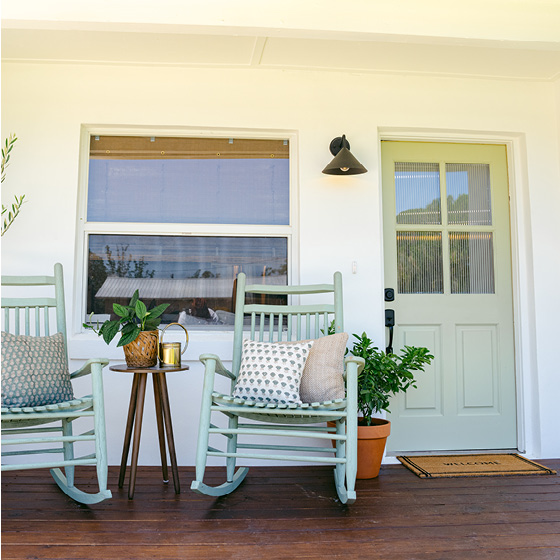 Six-image carousel of living room, child’s room, entryway, backyard and kitchen, all incorporating Renew Blue.